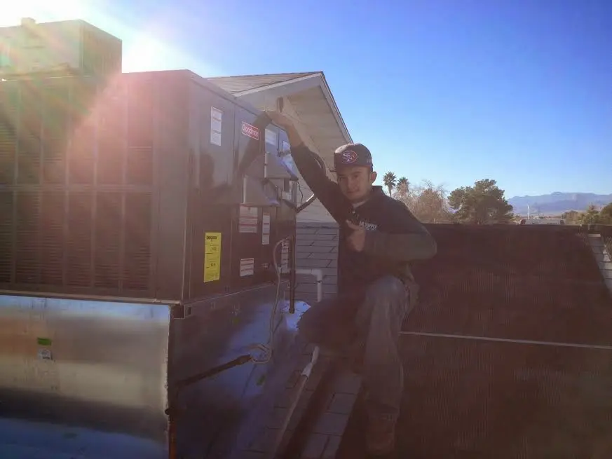 HVAC technician performing HVAC Inspection on a rooftop unit in Oak Forest